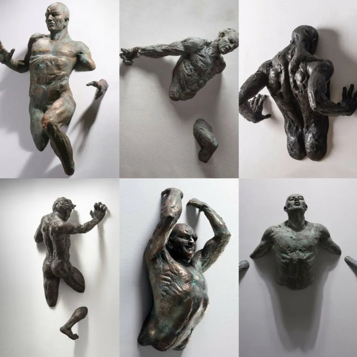 Sculpture homme grimpant traversant le mur imitation cuivre résine