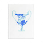 Une coupe en verre avec un motif floral bleu orné, sur un fond blanc.