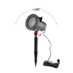 Lampe de projection installée sur une pelouse avec motifs colorés