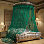 Un magnifique lit à baldaquin orné de rideaux verts vitrés, dans une pièce au décor luxueux.