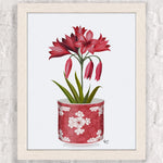Bouquet de fleurs rouges dans un pot décoratif motif fleuri.