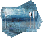 Set de 4 sets de table moderne avec motif abstrait bleu et gris sur une table à manger
