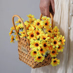 Panier en osier noir utilisé comme cache pot avec plantes vertes