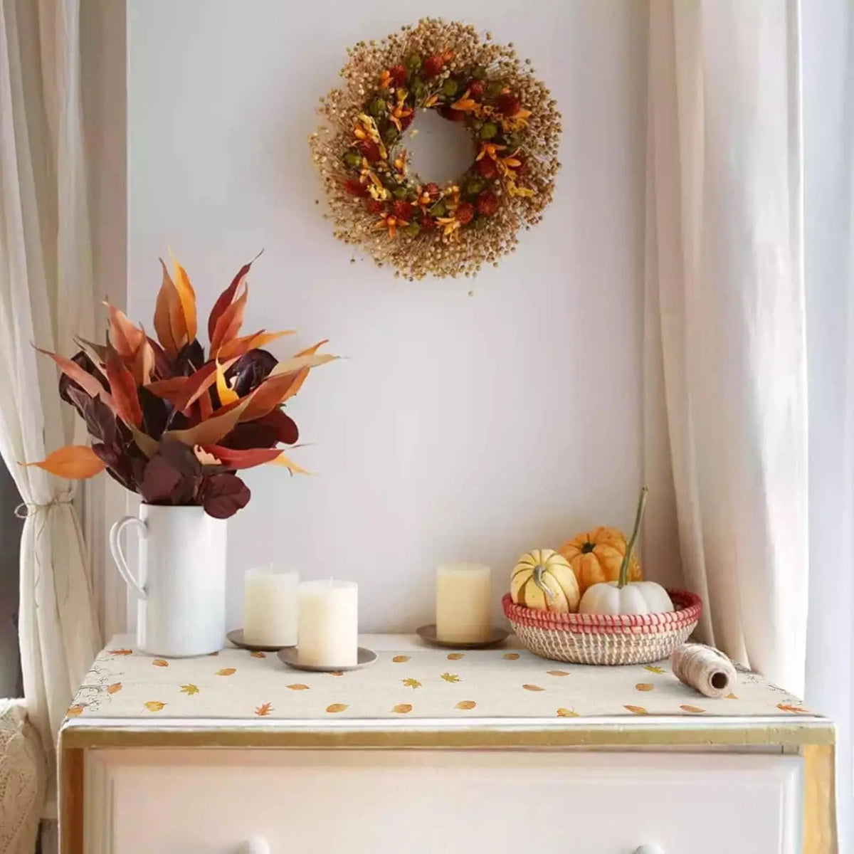 Une belle décoration d'automne composée d'un bouquet de fleurs colorées, d'une couronne de pommes de pin et de citrouilles dans un panier.
