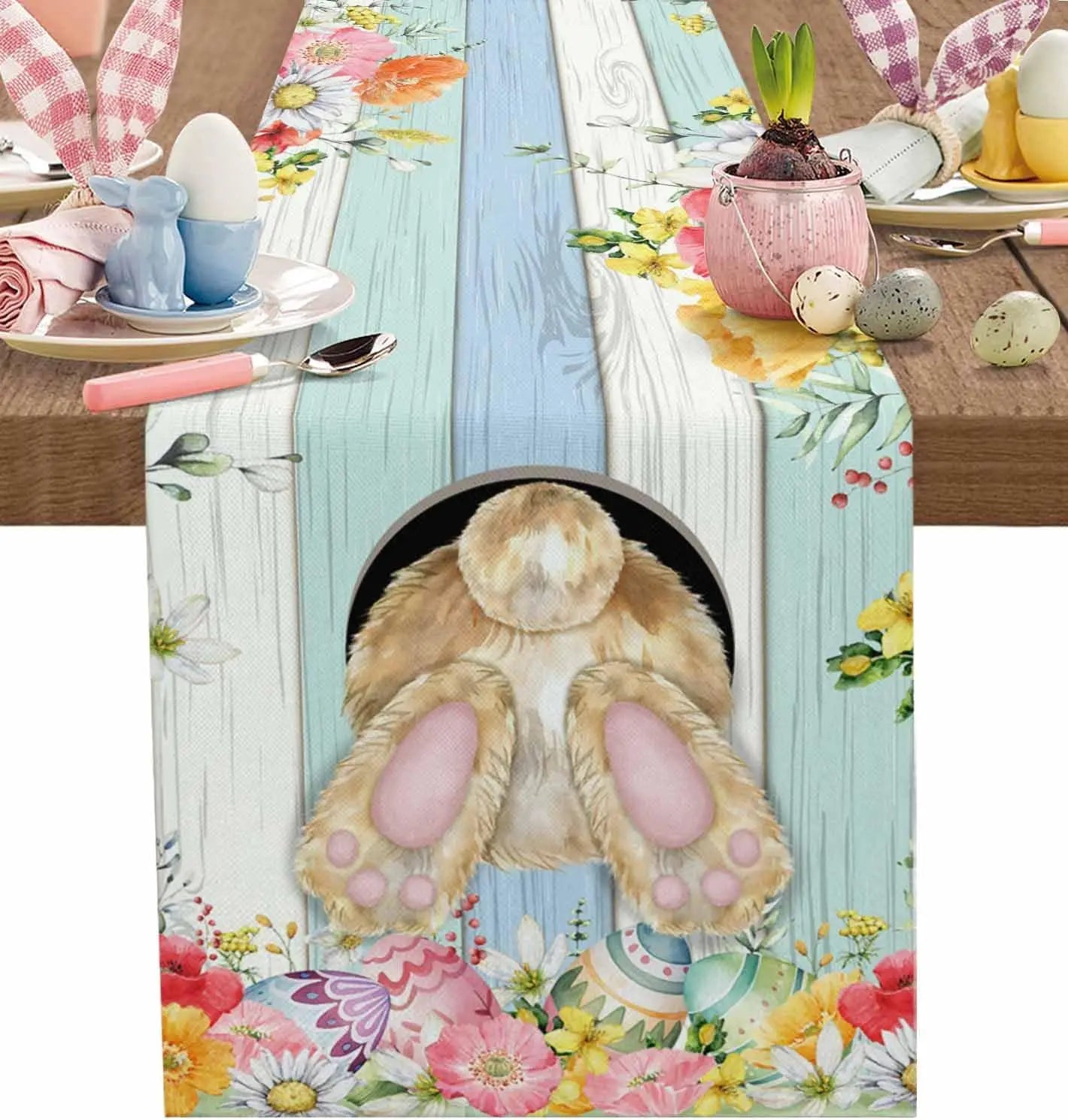 Une table de pâques joliment décorée avec des motifs floraux printaniers et un mignon animal de compagnie.