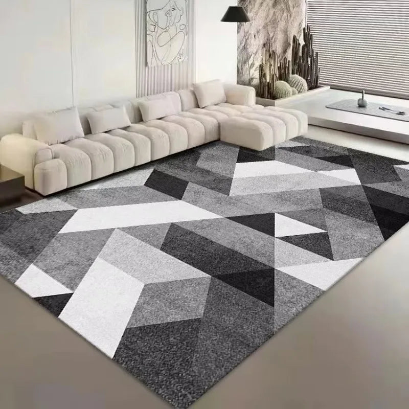 Un salon moderne avec un grand canapé d'angle beige et un tapis géométrique noir et blanc au sol, créant une atmosphère épurée et élégante.