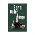 L'affiche montre un personnage masculin assis, vêtu d'un chandail noir, fumant une cigarette, et le titre "Born Under a Bad Sign" en grand format au-dessus.