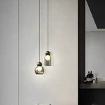Lampe suspendue grise en verre transparent et laiton