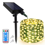 Guirlande lumineuse solaire 100 mètres LED blanc chaud dans un jardin