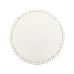 Miroir rond blanc avec de petits points noirs en bordure.