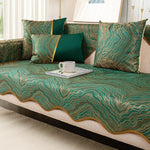 Un magnifique lit recouvert d'un édredon et d'oreillers de couleur verte et dorée, avec un motif ondulé dynamique et luxurieux.
