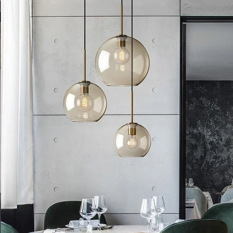 Lampe suspendue en verre verte suspendue au-dessus d'une table de cuisine