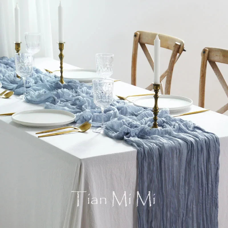 Une table dressée avec élégance, mettant en scène une nappe blanche, des décorations luxueuses et des accessoires dorés pour une ambiance chic et raffinée.