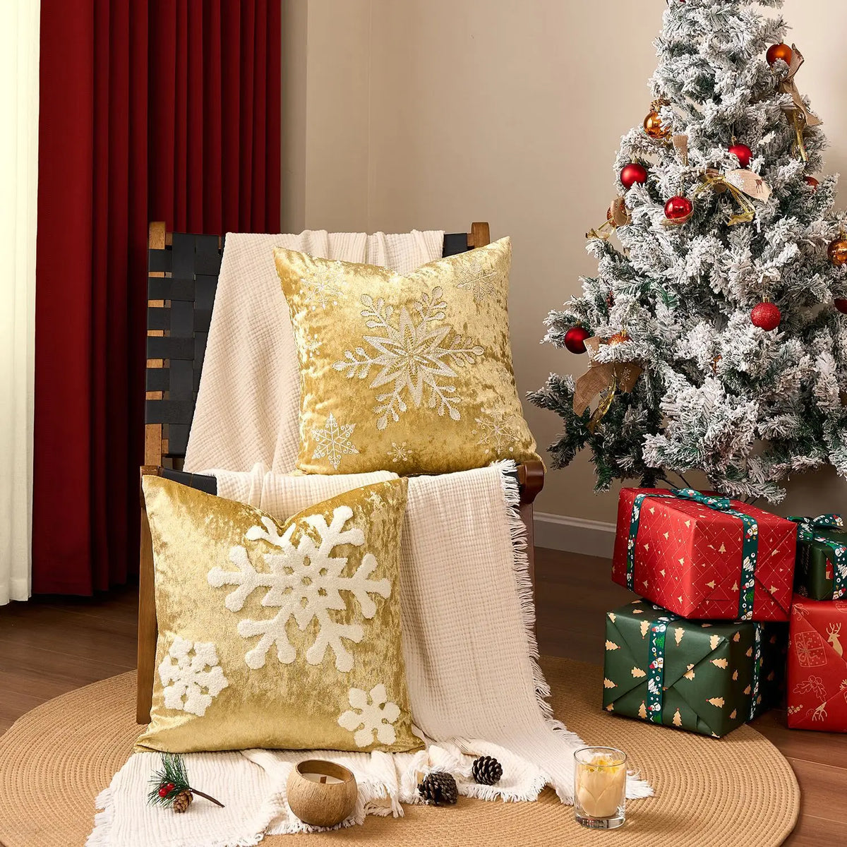 Une pièce accueillante décorée pour les fêtes, avec un sapin de Noël enneigé, des coussins dorés ornés de flocons de neige et des cadeaux emballés sous l'arbre.
