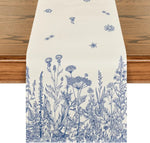 Un motif botanique détaillé avec une diversité de fleurs des champs et d'herbes sauvages imprimé sur un fond crème.