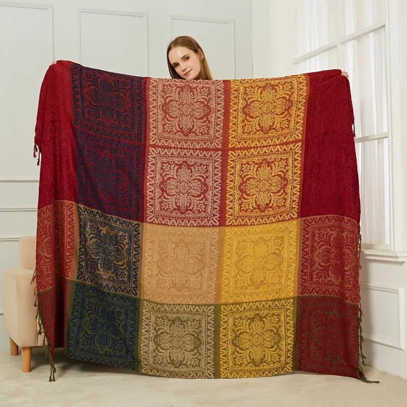 Une large couverture aux motifs floraux colorés au centre de laquelle se tient une femme, créant une scène apaisante et traditionnelle.