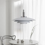 Lampe de chevet suspendue LED blanche design UFO accrochée au-dessus d'une table de chevet