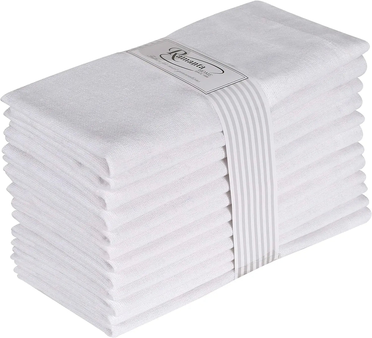 Des serviettes de bain blanches empilées soigneusement, avec une bande imprimée indiquant la marque "Cominca". Ces serviettes en coton doux et absorbant sont parfaites pour la salle de bain ou la douche.