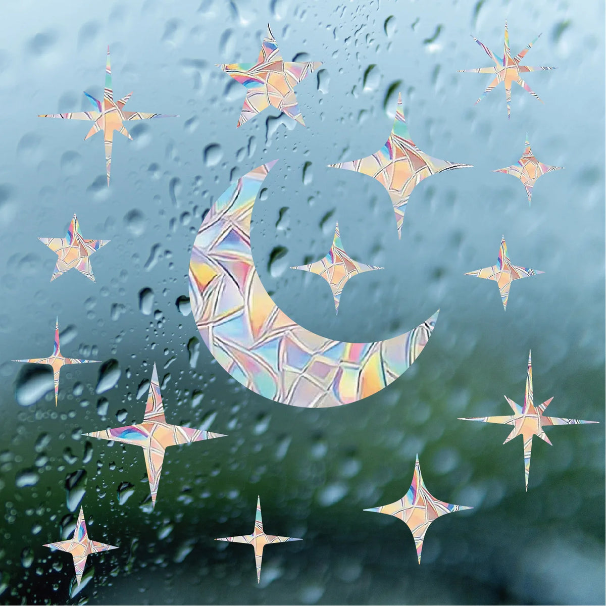 Autocollant suncatcher arc-en-ciel sur fenêtre en verre avec motifs lune et étoiles