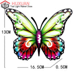 Papillon métal 2D sur mur de jardin