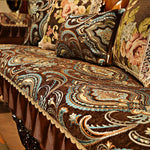 Cette magnifique couverture de canapé ornée de motifs géométriques et floraux en couleurs vives apporte une touche de sophistication et de chaleur à l'espace.