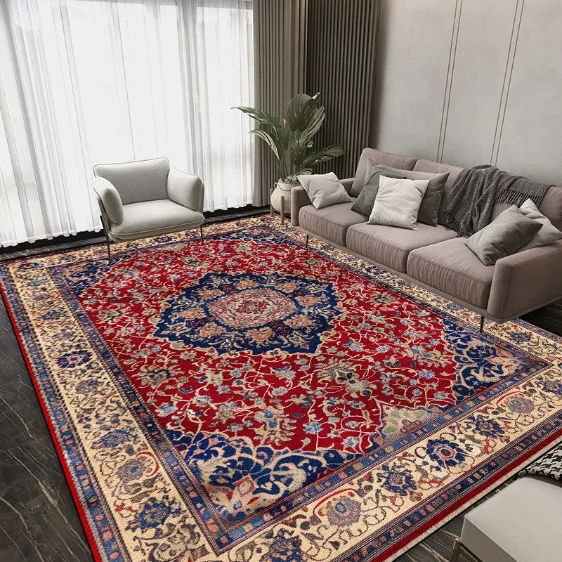 Tapis persan de style oriental avec un motif floral coloré et vibrant, posé sur un sol de pièce moderne avec des meubles gris.