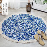 Tapis rond en coton avec motifs décoratifs bleus et blancs, créant un design artistique et élégant.
