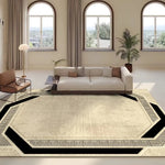 Un salon lumineux avec de grandes fenêtres, un canapé confortable et un tapis à motifs géométriques qui apporte une touche élégante et moderne à la pièce.