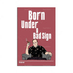L'image présente une affiche de la série télévisée "The Sopranos", avec le titre "Born Under a Bad Sign" et une illustration d'un personnage masculin assis dans un fauteuil, fumant une cigarette.