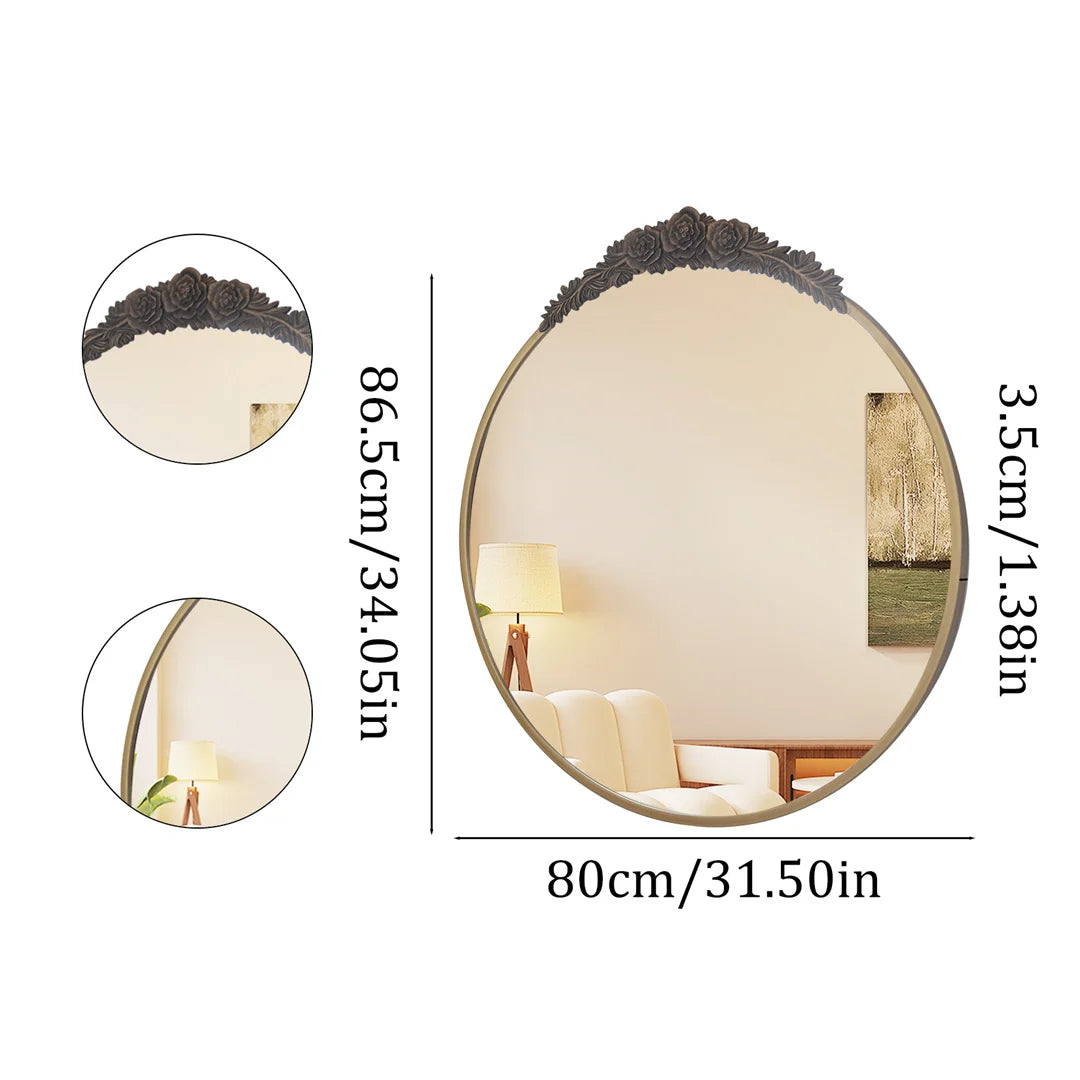 Miroir mural ovale décoratif avec cadre en métal noir et motif de fleurs en relief, offrant une surface réflective pour créer une atmosphère apaisante dans une pièce.