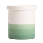 Pot de plantes bicolore blanc et vert pastel, avec un couvercle, utilisé pour ranger ou exposer des objets décoratifs.