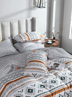 Ensemble housse de couette et taies d'oreiller orange dépliées