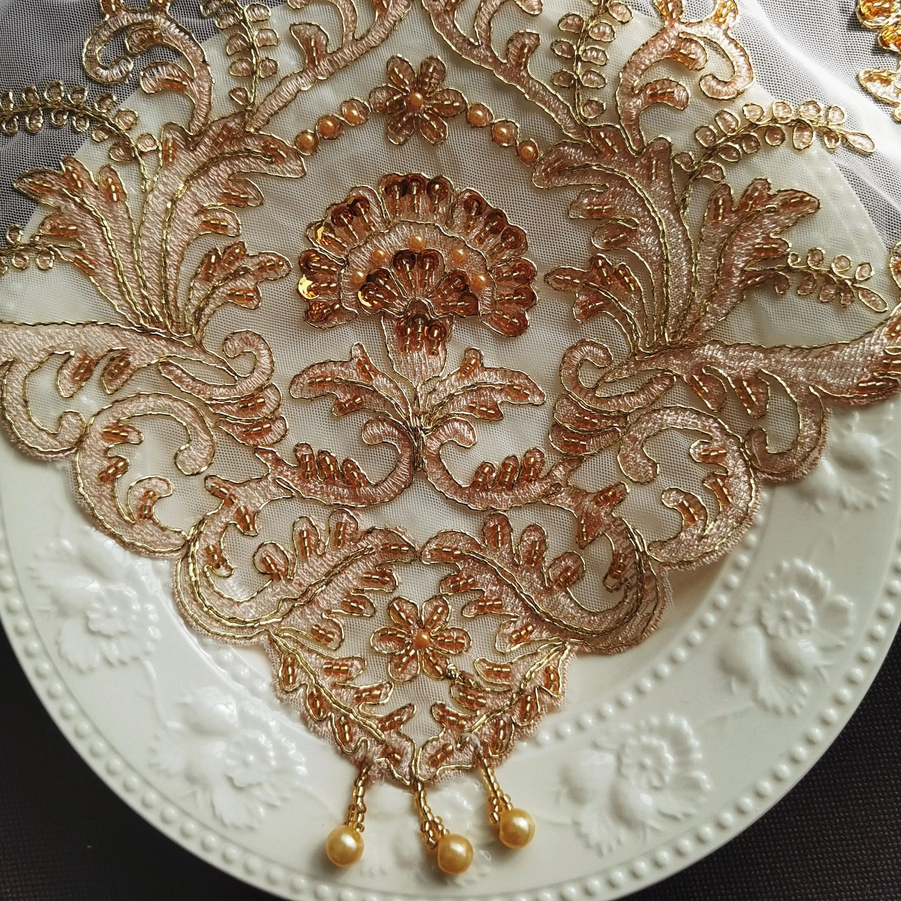 Set de table luxe brodé posé sur une nappe blanche