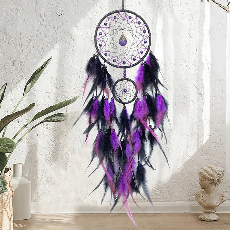 Un attrape-rêves violet et noir suspendu au mur, orné de perles et de plumes, évoquant la spiritualité et la méditation.