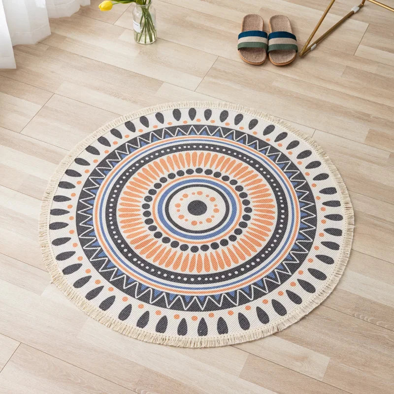 Un tapis rond, motifs ethniques et géométriques, aux tons chauds et contrastés, posé sur un sol en bois clair, complété par des sandales en mailles.