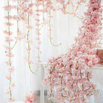 Guirlande de fleurs artificielles en soie rose de 1.8m suspendue dans un intérieur