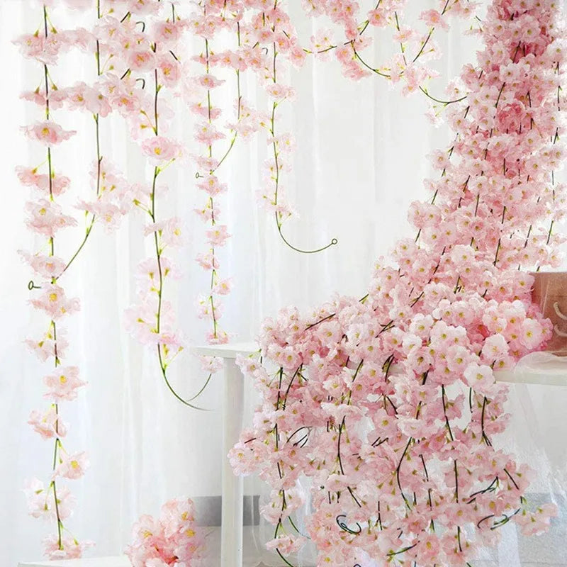 Guirlande de fleurs artificielles en soie rose de 1.8m suspendue dans un intérieur