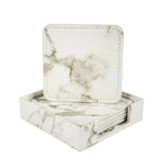 Ensemble de sous-verres carrés avec impression marbrée blanche et grise, rangés dans un support coordonné, idéaux pour décorer et protéger les surfaces.
