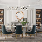 Une salle à manger élégante avec un lustre moderne, une table en marbre et des chaises en velours sombre.