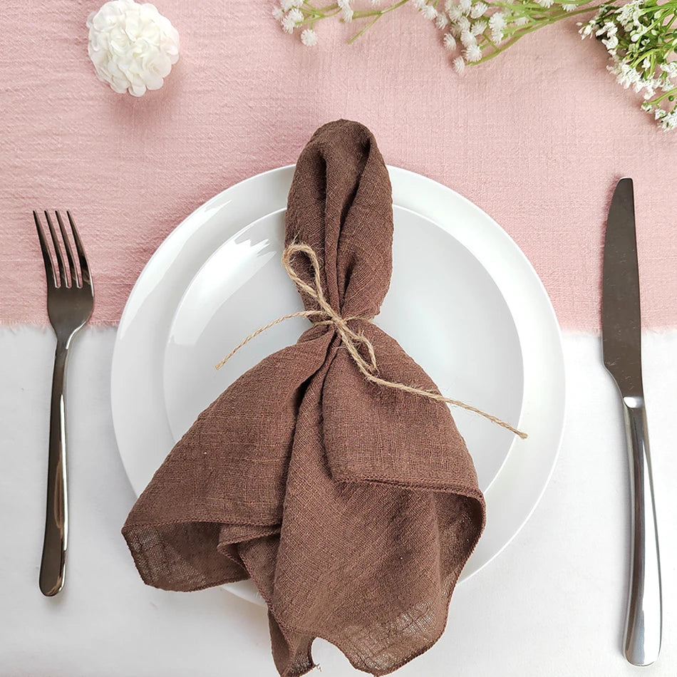 Une table élégante avec des ustensiles et un magnifique bouquet de fleurs blanches sur un fond rose.