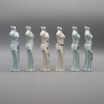 Une série de six figurines en céramique peintes à la main, représentant des formes féminines stylisées avec des motifs floraux et géométriques.