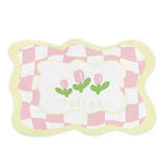 Coussin décoratif carrelage rose et blanc avec fleurs stylisées.