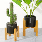 Support de plante en bois design avec pot vert
