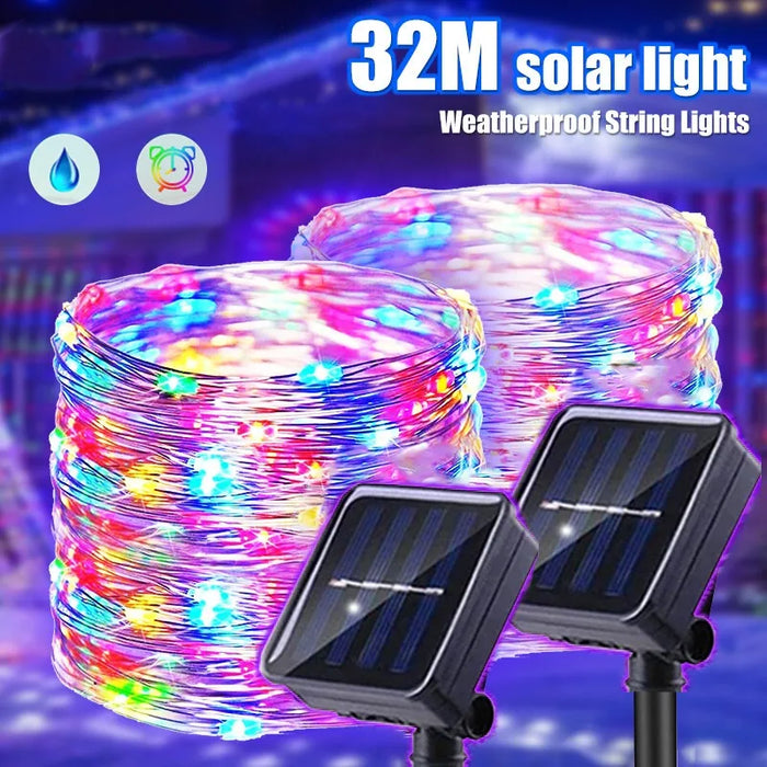Guirlande solaire extérieure 32M 300LED étanche IP65 illuminant un jardin la nuit