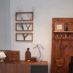 Art mural en bois flotté accroché dans un salon moderne avec décoration naturelle