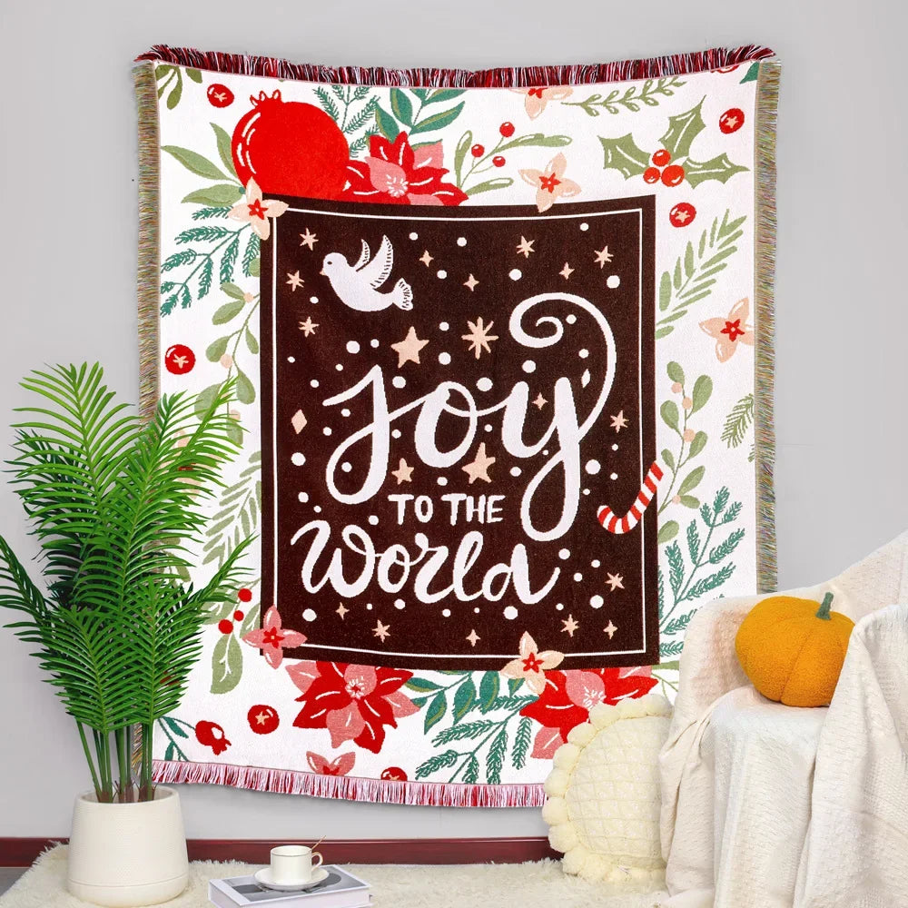 Cette couverture ornée de motifs festifs, avec le texte "Joie au monde", crée une ambiance chaleureuse et invitante pour les fêtes de Noël.
