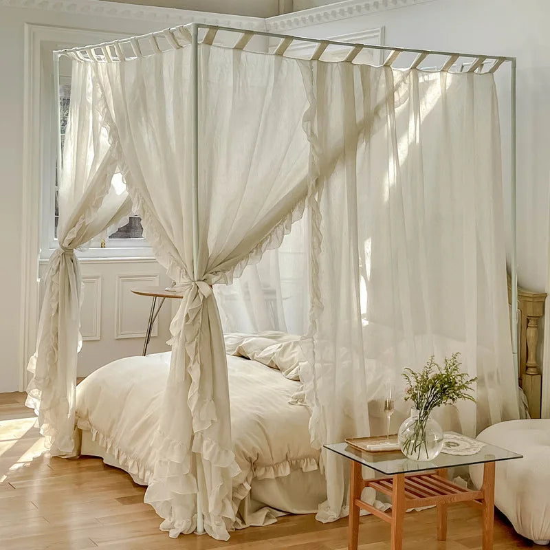 Chambre spacieuse avec un lit à baldaquin en lin blanc, une table de chevet en bois et de la végétation décorative.