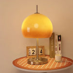 Lampe de chevet orange vintage en verre sur table de nuit