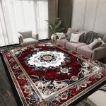 Tapis persan vintage au motif floral coloré et complexe, décorant un salon moderne avec des meubles gris et beiges.
