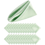 Un mouchoir de poche en satin vert clair plié avec soin pour compléter l'élégance d'une tenue.